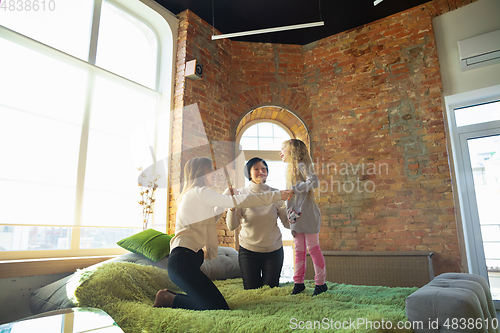 Image of Happy loving family. Grandmother, mother and daughter spending time together