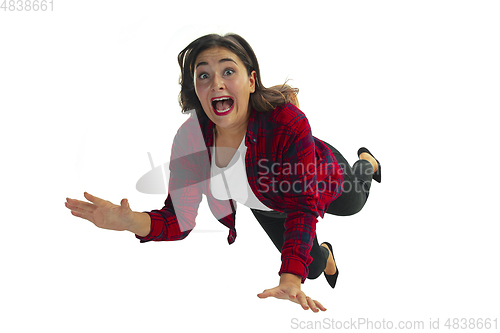 Image of A second before falling - young girl falling down with bright emotions and expression