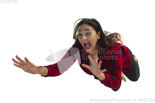 Image of A second before falling - young girl falling down with bright emotions and expression