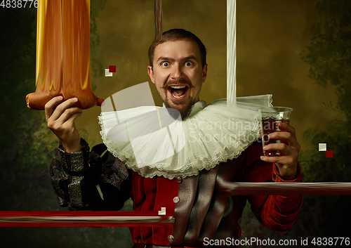 Image of Young man as a medieval knight on dark background, stylish creative design