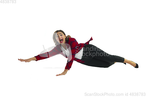 Image of A second before falling - young girl falling down with bright emotions and expression