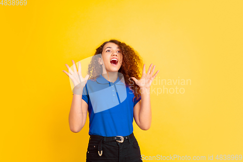Image of Caucasian teen\'s girl portrait on yellow background