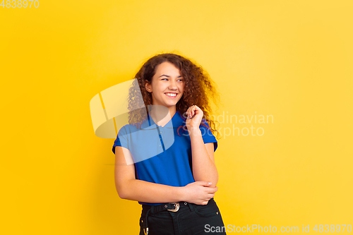 Image of Caucasian teen\'s girl portrait on yellow background