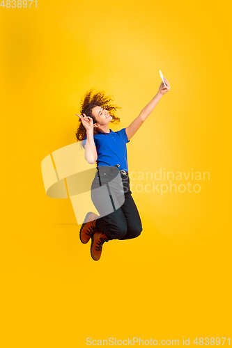 Image of Caucasian teen\'s girl portrait on yellow background