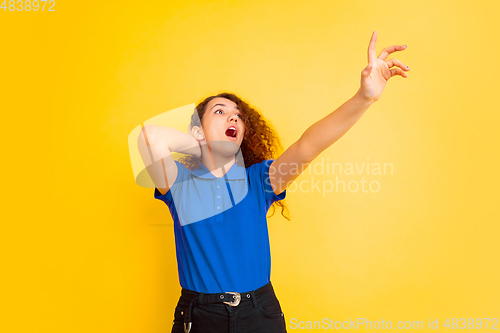 Image of Caucasian teen\'s girl portrait on yellow background