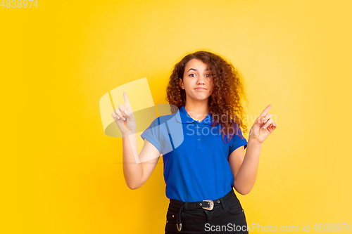 Image of Caucasian teen\'s girl portrait on yellow background