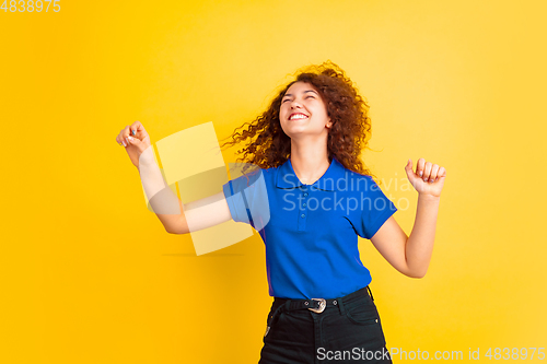 Image of Caucasian teen\'s girl portrait on yellow background