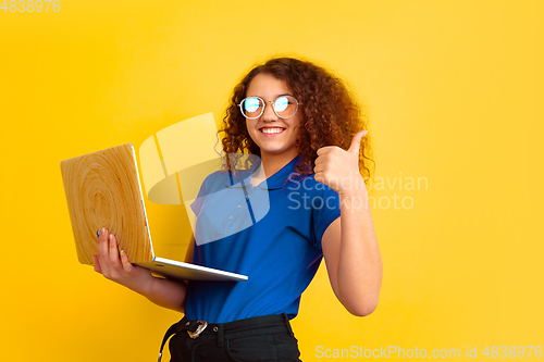 Image of Caucasian teen\'s girl portrait on yellow background