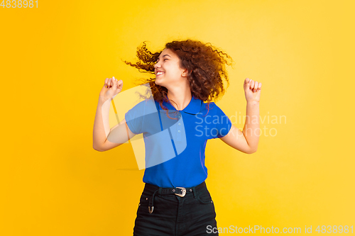 Image of Caucasian teen\'s girl portrait on yellow background