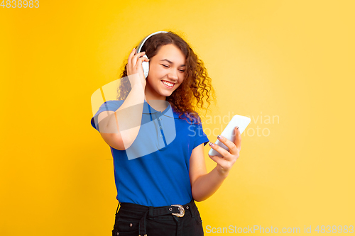 Image of Caucasian teen\'s girl portrait on yellow background