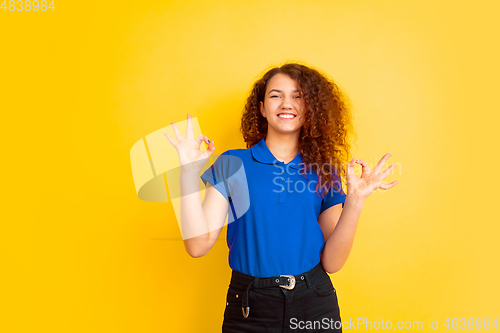 Image of Caucasian teen\'s girl portrait on yellow background