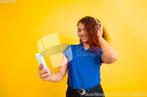 Image of Caucasian teen\'s girl portrait on yellow background