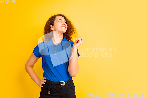 Image of Caucasian teen\'s girl portrait on yellow background