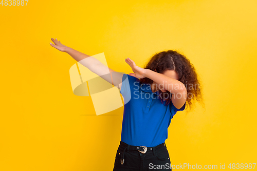 Image of Caucasian teen\'s girl portrait on yellow background