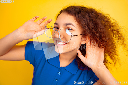 Image of Caucasian teen\'s girl portrait on yellow background