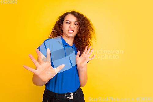 Image of Caucasian teen\'s girl portrait on yellow background