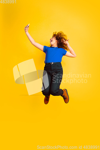 Image of Caucasian teen\'s girl portrait on yellow background
