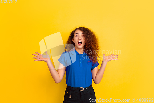 Image of Caucasian teen\'s girl portrait on yellow background