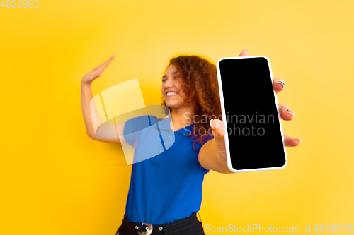 Image of Caucasian teen\'s girl portrait on yellow background