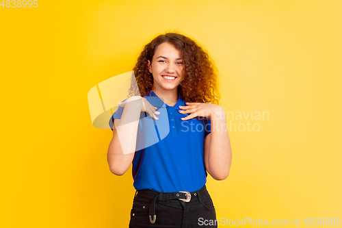 Image of Caucasian teen\'s girl portrait on yellow background