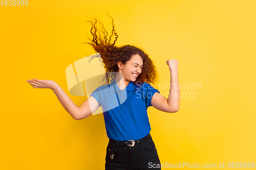 Image of Caucasian teen\'s girl portrait on yellow background