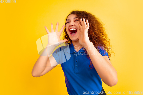 Image of Caucasian teen\'s girl portrait on yellow background