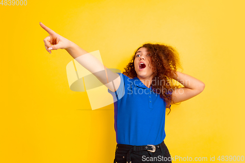 Image of Caucasian teen\'s girl portrait on yellow background