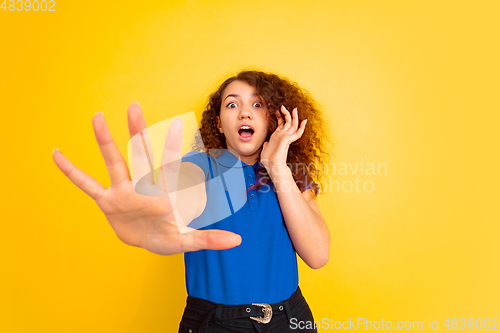 Image of Caucasian teen\'s girl portrait on yellow background