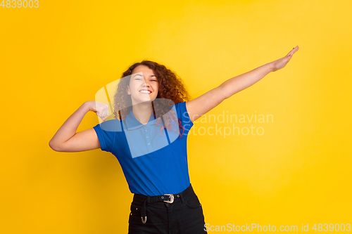 Image of Caucasian teen\'s girl portrait on yellow background