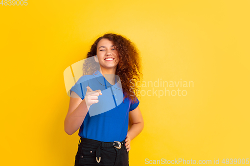 Image of Caucasian teen\'s girl portrait on yellow background