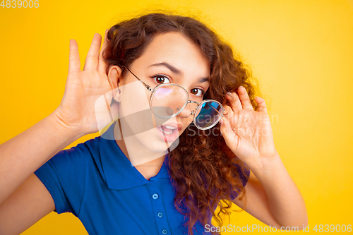 Image of Caucasian teen\'s girl portrait on yellow background