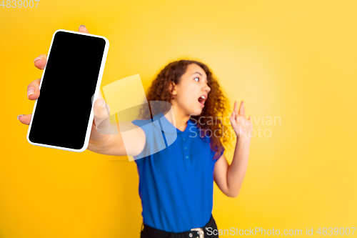 Image of Caucasian teen\'s girl portrait on yellow background