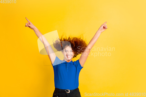Image of Caucasian teen\'s girl portrait on yellow background