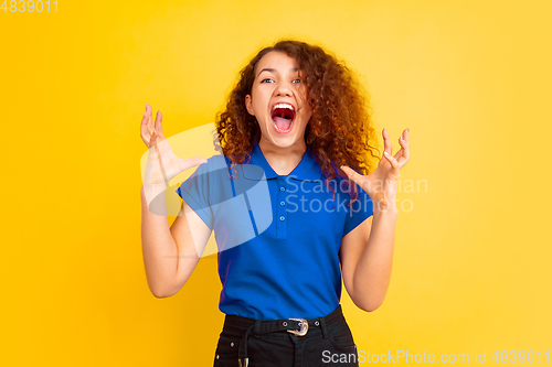 Image of Caucasian teen\'s girl portrait on yellow background