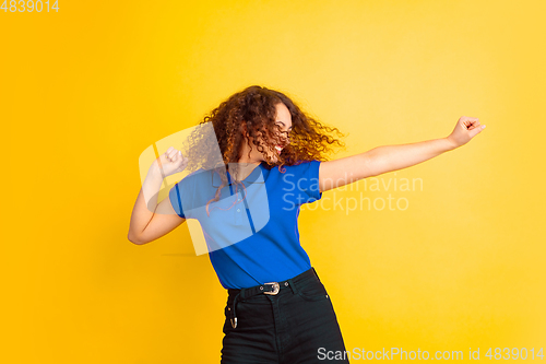 Image of Caucasian teen\'s girl portrait on yellow background