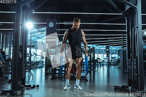 Image of The male athlete training hard in the gym. Fitness and healthy life concept.