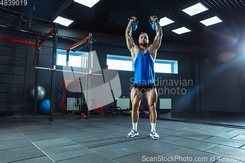 Image of The male athlete training hard in the gym. Fitness and healthy life concept.