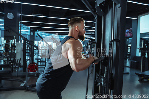 Image of The male athlete training hard in the gym. Fitness and healthy life concept.