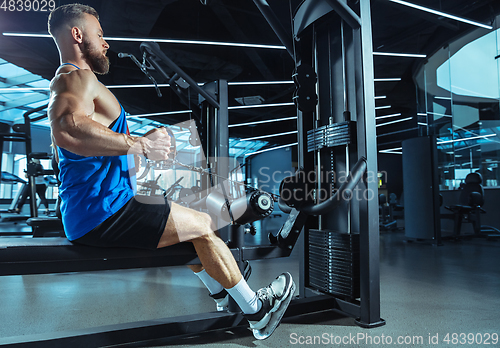 Image of The male athlete training hard in the gym. Fitness and healthy life concept.