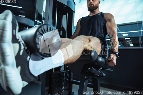 Image of The male athlete training hard in the gym. Fitness and healthy life concept.