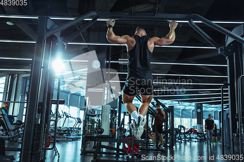 Image of The male athlete training hard in the gym. Fitness and healthy life concept.