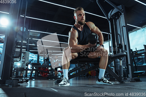 Image of The male athlete training hard in the gym. Fitness and healthy life concept.