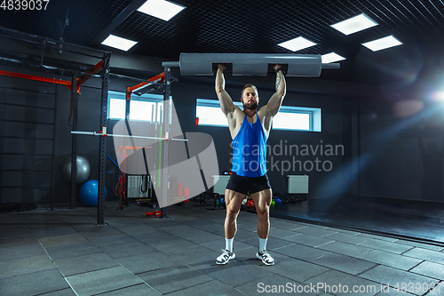 Image of The male athlete training hard in the gym. Fitness and healthy life concept.