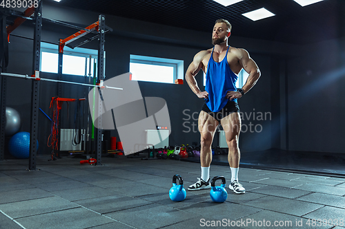 Image of The male athlete training hard in the gym. Fitness and healthy life concept.