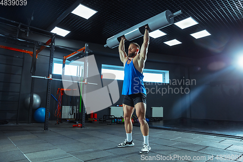 Image of The male athlete training hard in the gym. Fitness and healthy life concept.