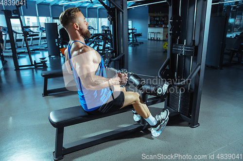 Image of The male athlete training hard in the gym. Fitness and healthy life concept.