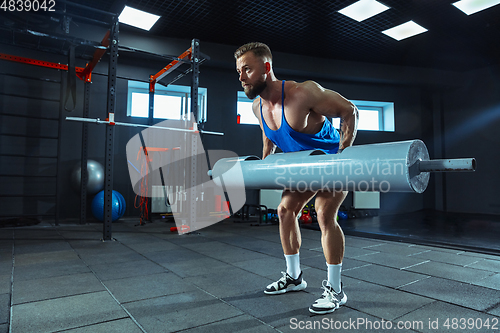 Image of The male athlete training hard in the gym. Fitness and healthy life concept.