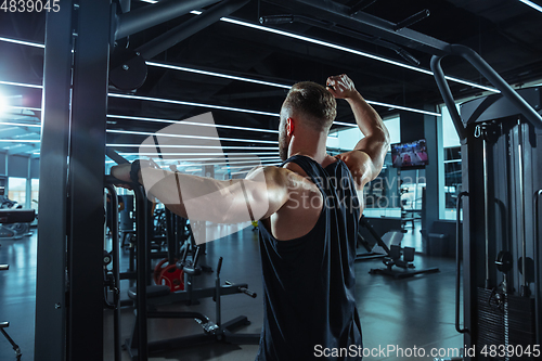 Image of The male athlete training hard in the gym. Fitness and healthy life concept.