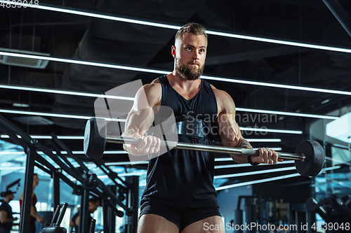 Image of The male athlete training hard in the gym. Fitness and healthy life concept.