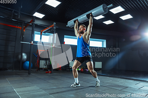 Image of The male athlete training hard in the gym. Fitness and healthy life concept.